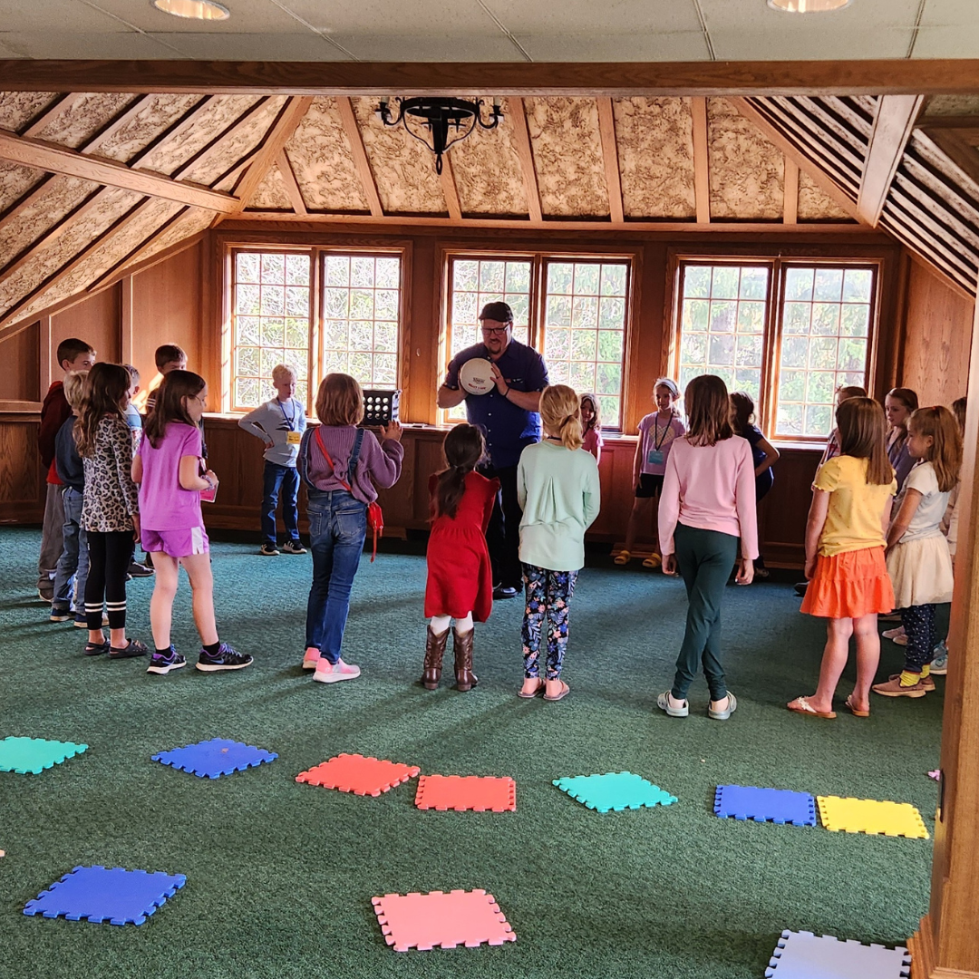 children in a circle playing ball